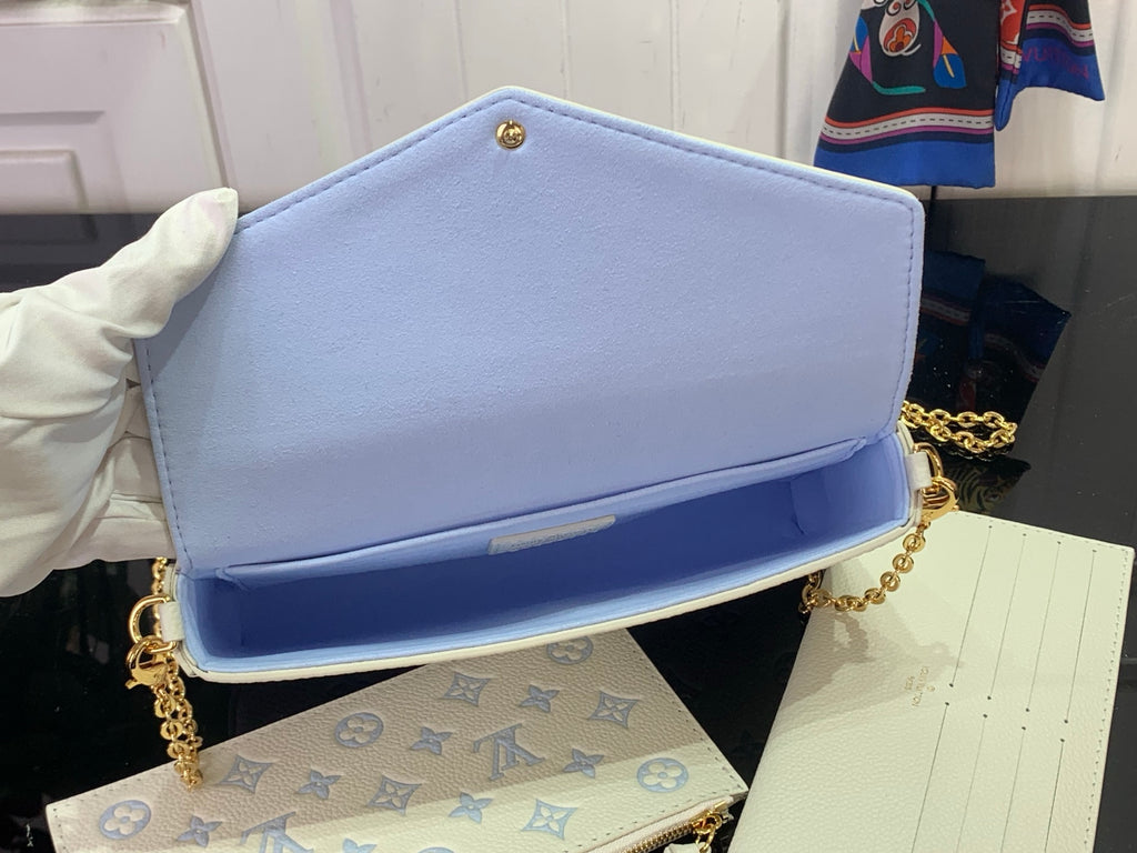 Louis Vuitton crossbody bag with light blue flap and white blue monogram front, gold chain