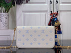 Louis Vuitton crossbody bag with white exterior and blue monogram pattern, front flap closed