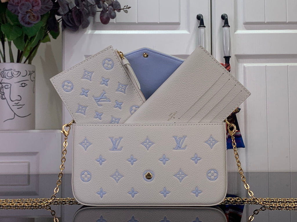 Louis Vuitton crossbody bag in white with blue monogram, flap open showing light blue lining