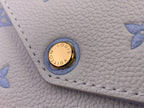 Louis Vuitton logo snap button on light blue textured leather bag