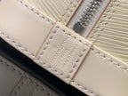 Louis Vuitton logo patch on cream leather strap with visible stitching