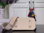 Cream Louis Vuitton handbag with short handles and crossbody strap attached
