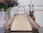 Cream Louis Vuitton handbag with top handles and long logo shoulder strap