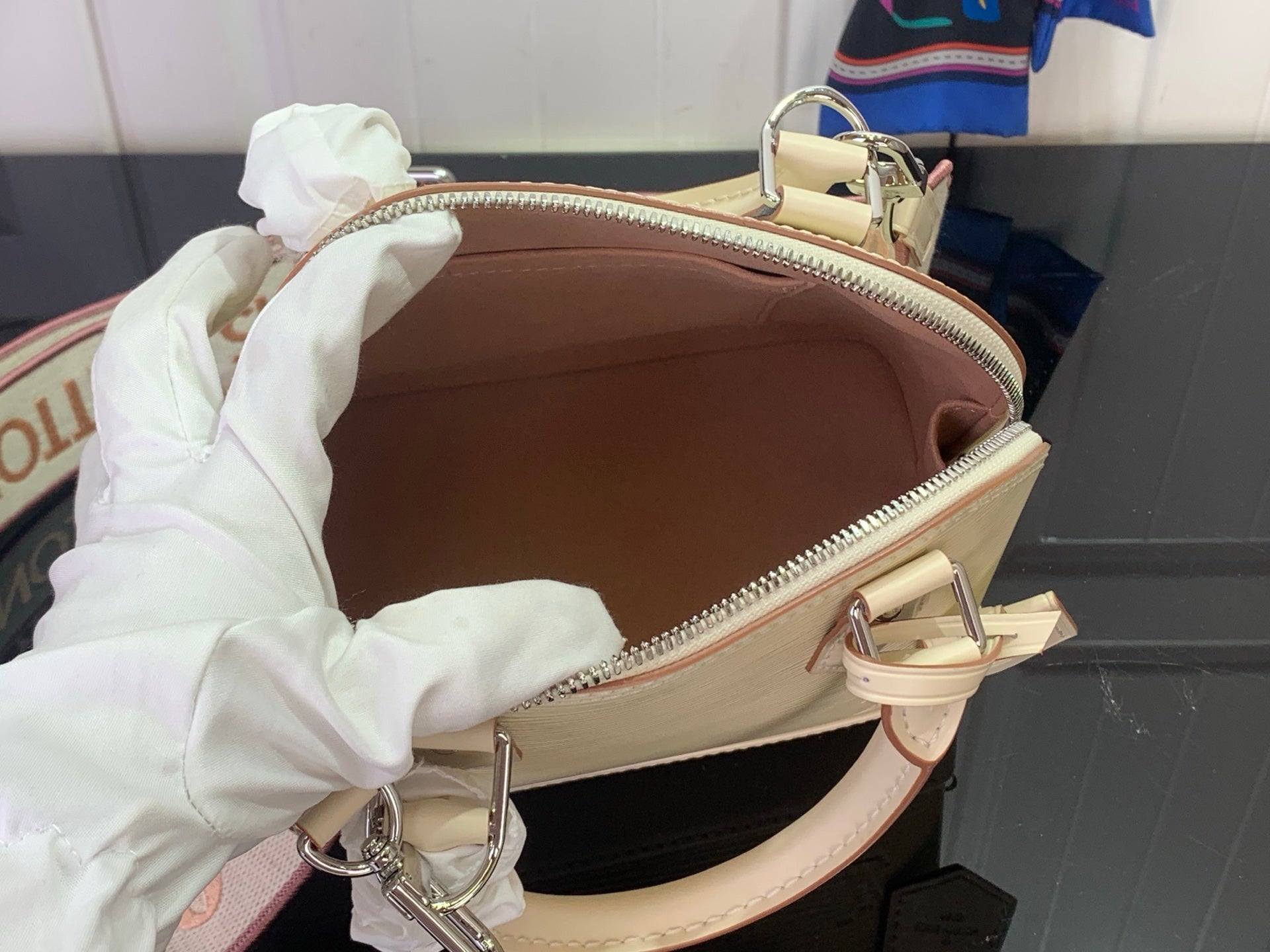 Cream Louis Vuitton handbag interior with brown lining and open zip pocket