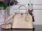 Cream structured Louis Vuitton handbag with top handles, front logo charm and tabs