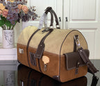 Louis Vuitton duffel bag with tan monogram canvas, dark leather straps, front pocket and buckles