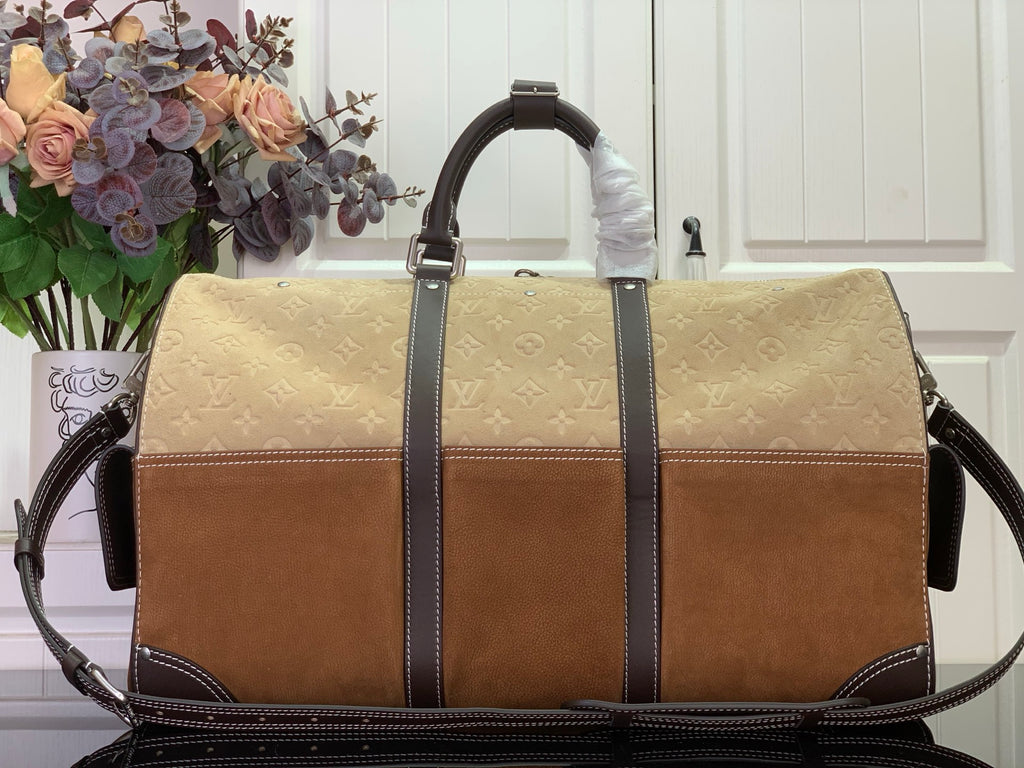Louis Vuitton duffel bag front view in tan monogram canvas with dark vertical leather straps