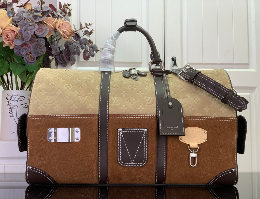 Louis Vuitton duffel bag in brown and tan with dark leather trim, top handles and logo patch