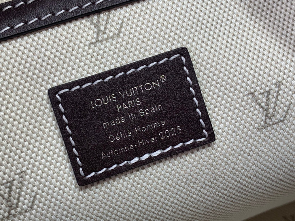 Louis Vuitton fabric label patch with dark border on beige interior trim