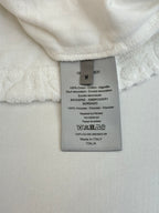 Dior knit top size and fabric care label on white short-sleeve top