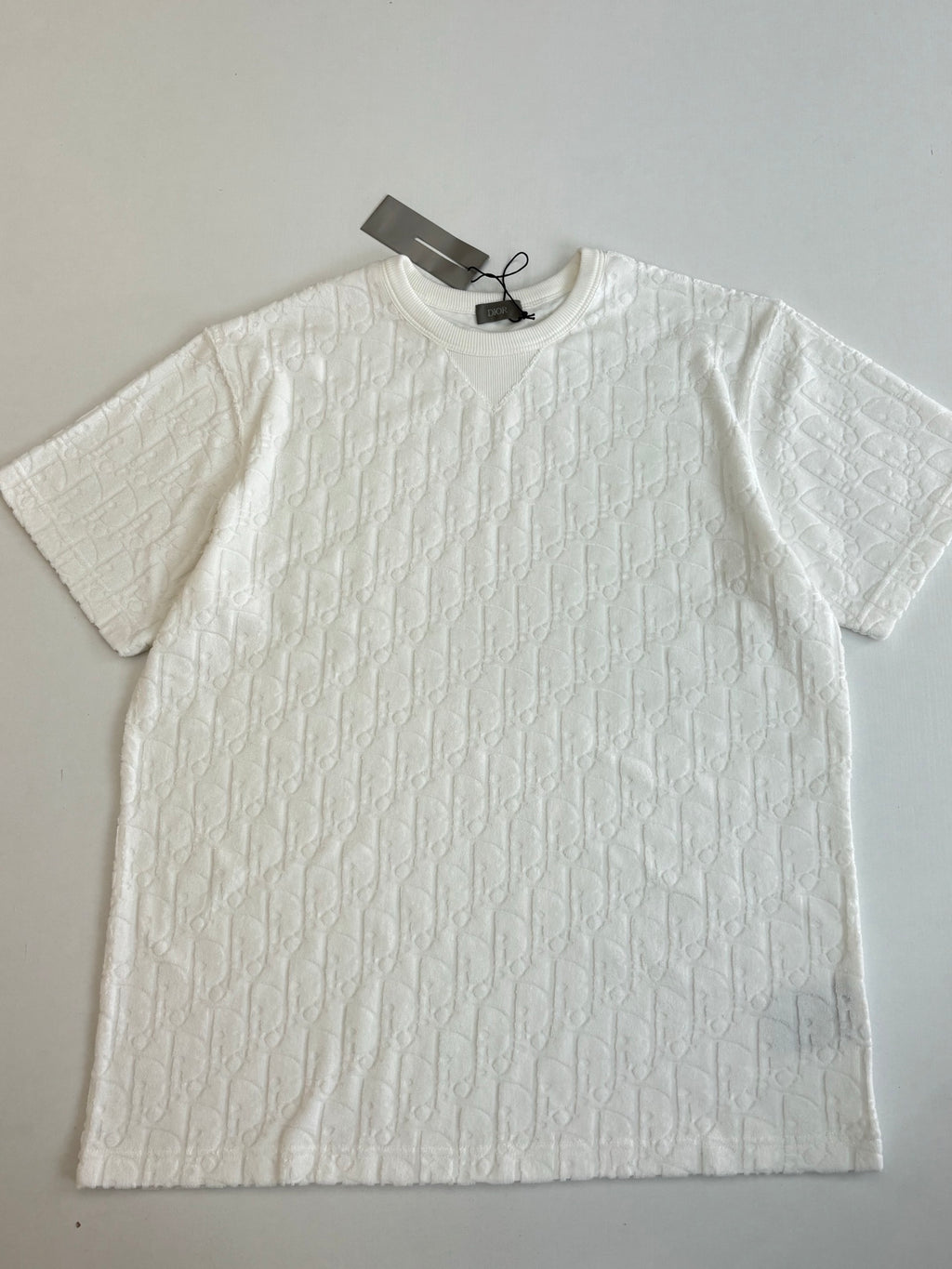 Dior white short-sleeve knit top close-up with crew neck and raised textured pattern