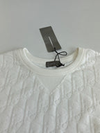Dior white knit top neckline close-up with crew neck and raised embossed pattern