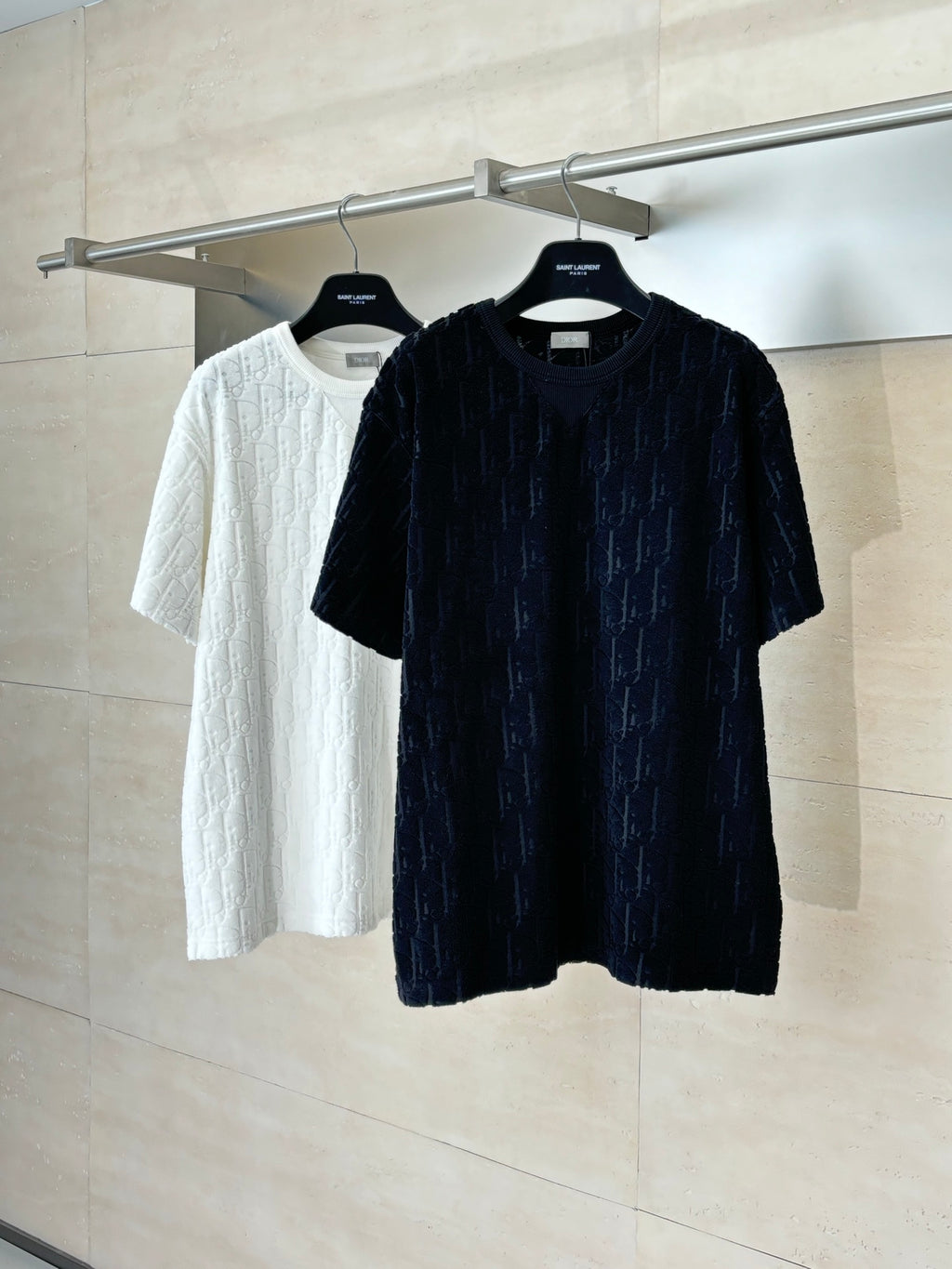 Short-sleeve knit top on hanger, dark textured logo knit; crew neckline