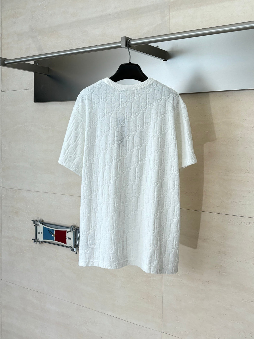Dior white short-sleeve knit top back view with crew neck and raised textured pattern