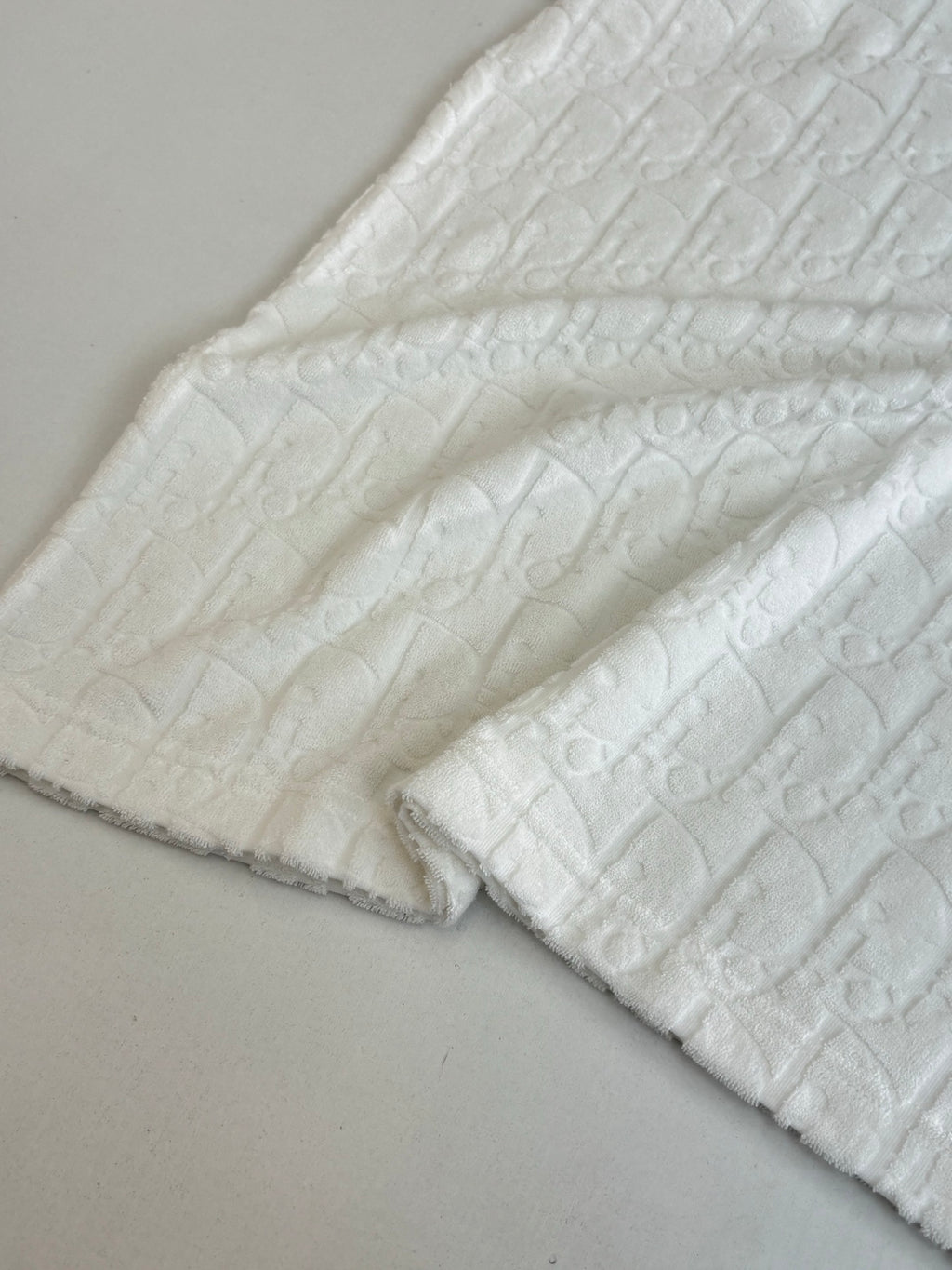 Dior white knit top sleeve and hem close-up with raised textured weave