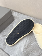 Balenciaga cream slide sandal outsole, dark textured tread with logo