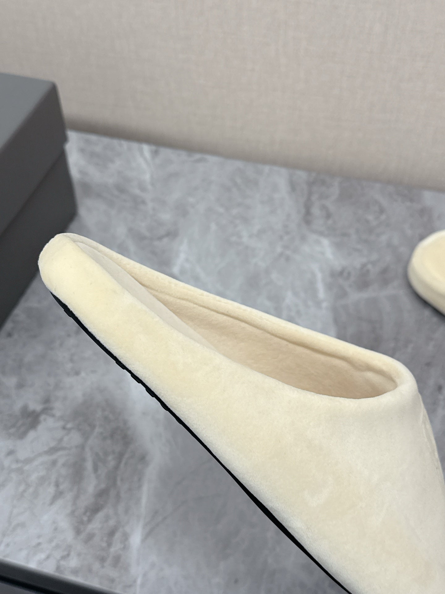 Balenciaga cream slide sandal side view, smooth cushioned upper