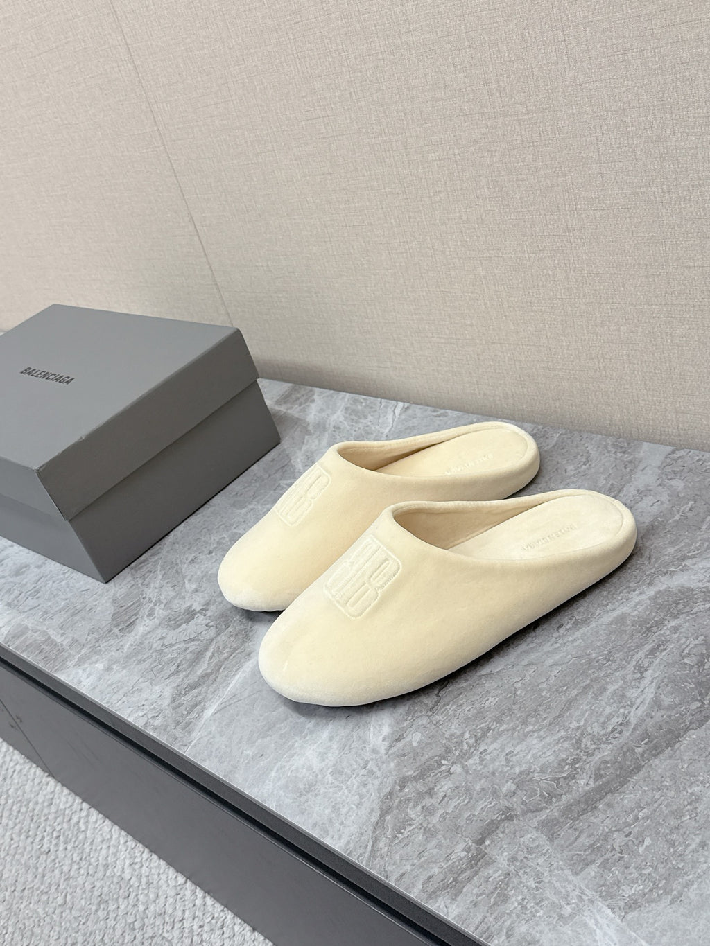 Balenciaga cream slide sandals with cushioned footbed and front logo