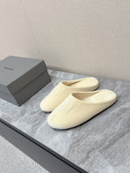Balenciaga cream slide sandals with cushioned footbed and front logo
