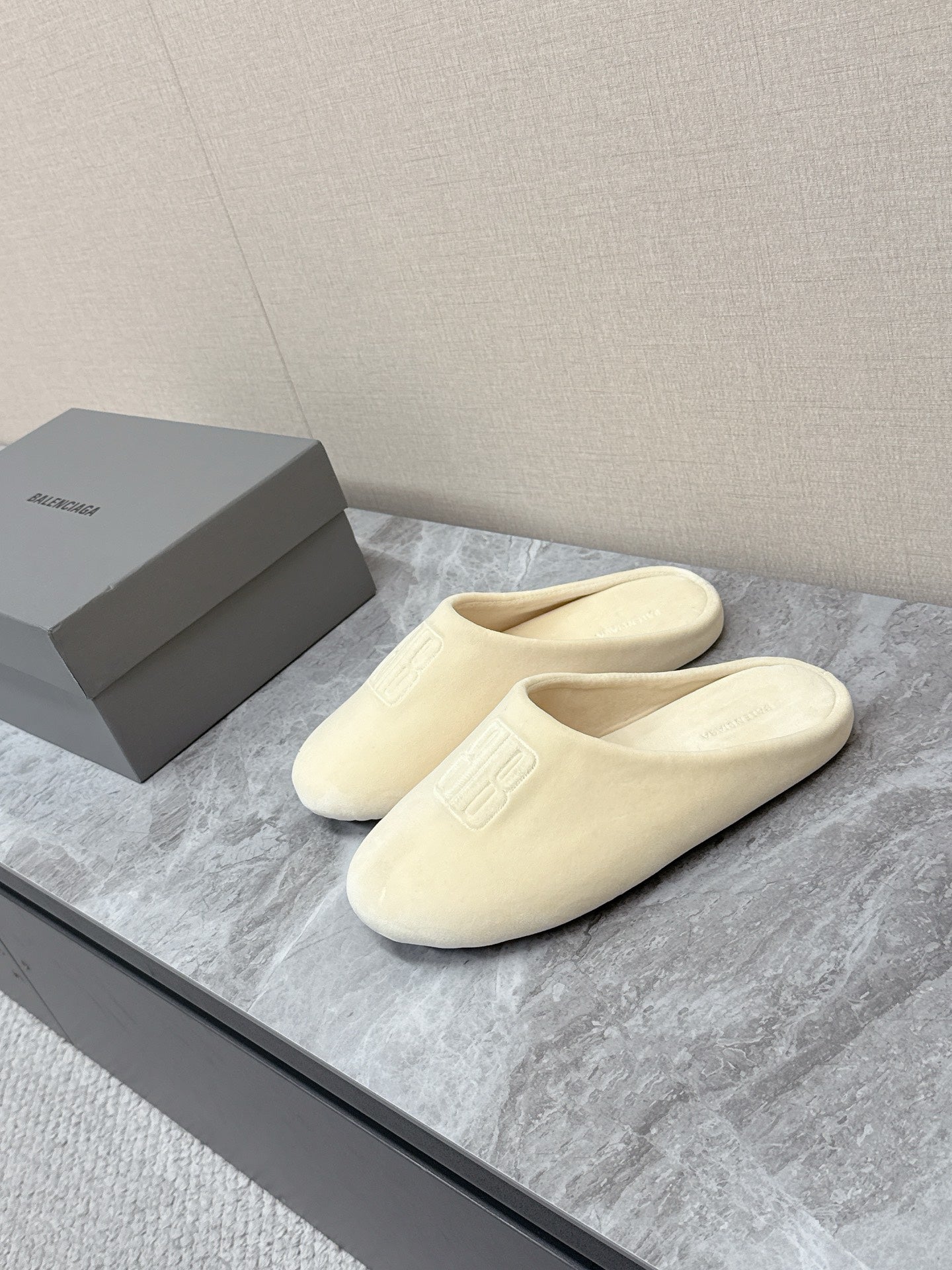 Balenciaga cream slide sandals with cushioned footbed and front logo