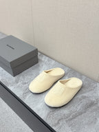 Balenciaga cream slide sandals with front logo detail, cushioned slip-on design