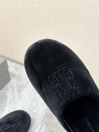 Black velvet slide sandal with embossed Balenciaga logo on upper, close-up