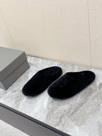 Black slide sandals with embossed Balenciaga logo, side-by-side view