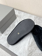 Rubber outsole for black slide sandals, textured grip tread with small logo