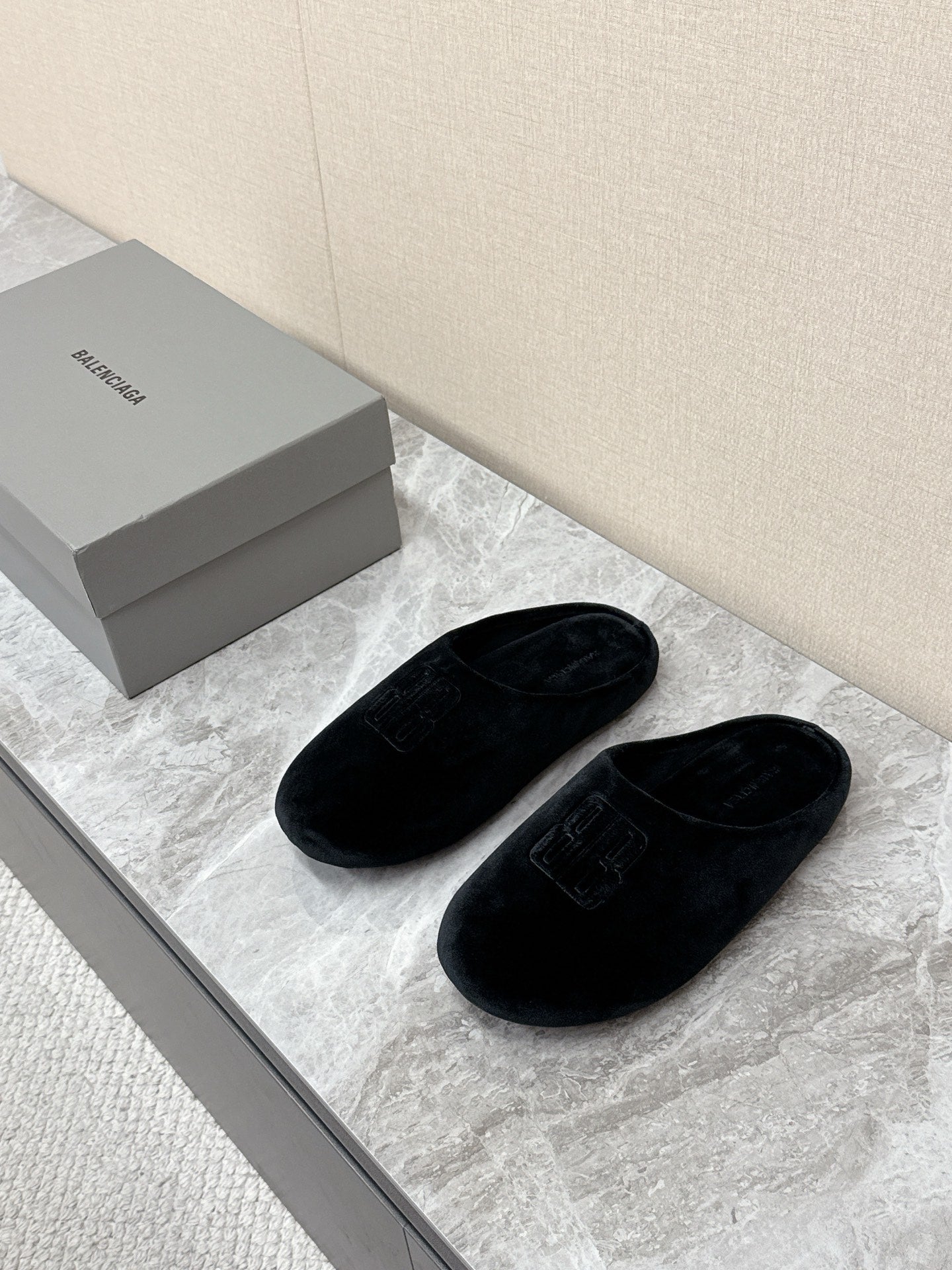 Black slide sandals with embossed Balenciaga logo, plush velvet upper