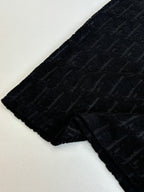 Short-sleeve knit sleeve section, dark textured fabric with raised logo pattern