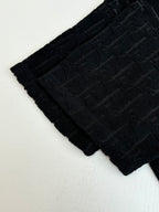 Textured knit fabric detail, dark allover logo pattern across sleeve