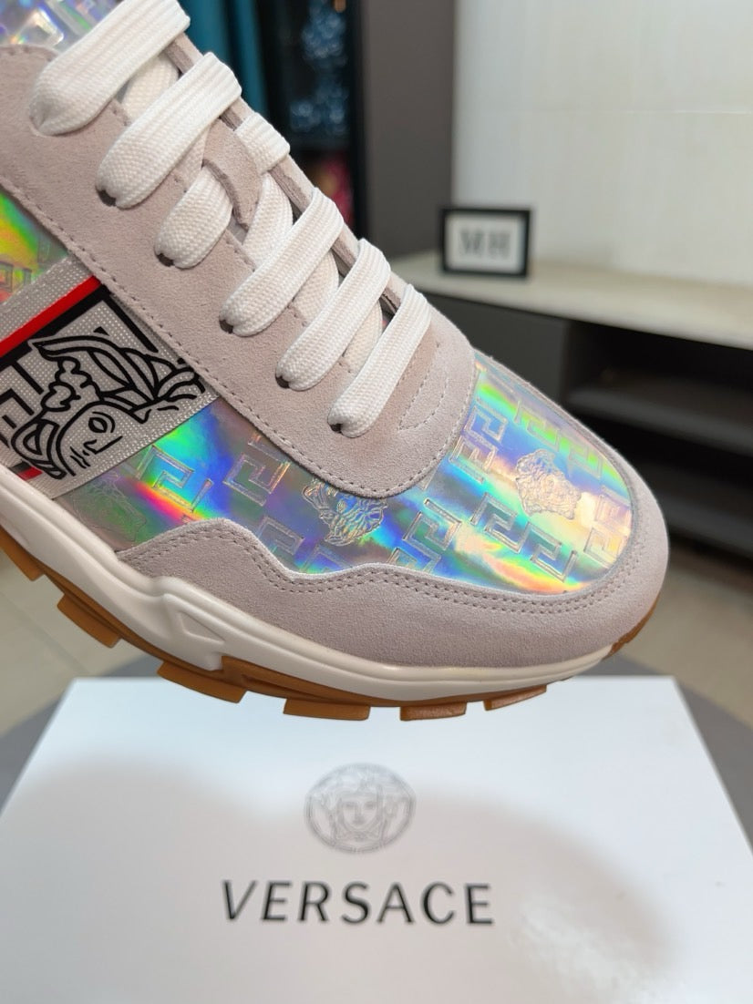 Light gray lace-up sneakers with iridescent logo graphic and chunky rubber sole.