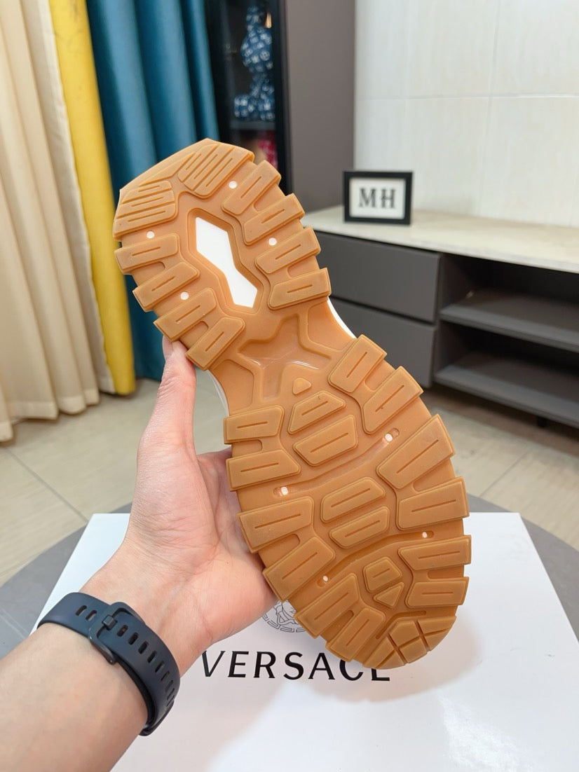 Tan rubber outsole tread of chunky sneakers, underside view.