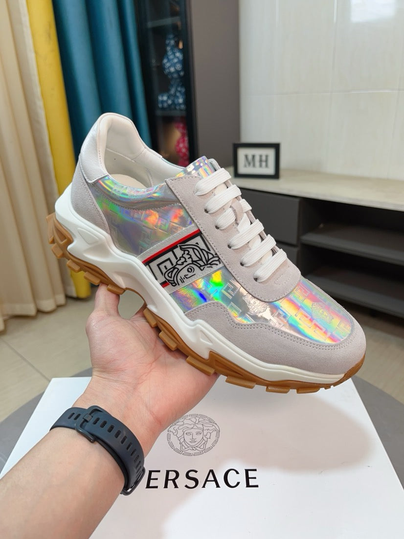 Light gray/white lace-up sneakers with holographic panel, chunky rubber sole, hand-held.