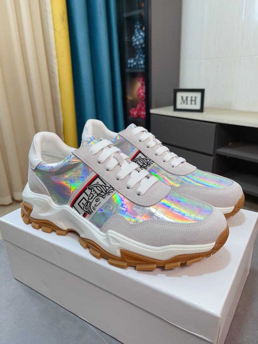 White/gray lace-up sneakers with iridescent graphic, chunky rubber sole.