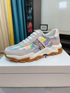 Light gray/white lace-up sneakers with iridescent print, chunky rubber sole.