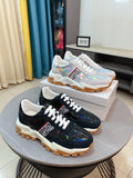 Black Versace sneakers with iridescent accents, chunky rubber sole, lace-up front.