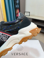 Versace lace-up sneaker, side view with black glossy upper and chunky tread outsole