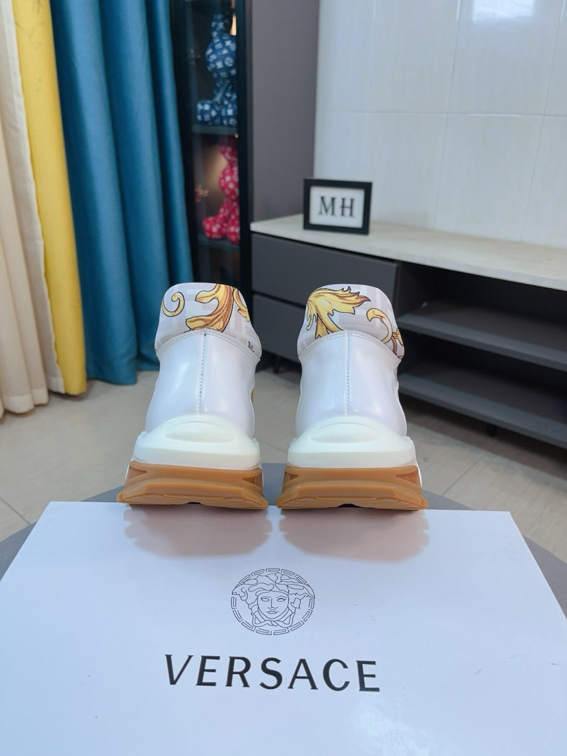 Versace luxury sneakers, back view of white shoes with gold heel motif on box