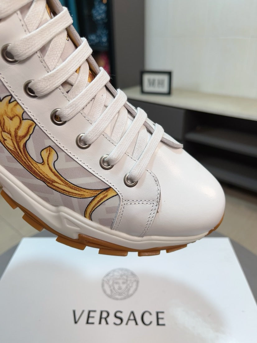 Versace luxury sneaker, close-up of white laces and gold side emblem on sole