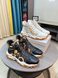Versace luxury sneakers, black pair with gold crest print and chunky white sole