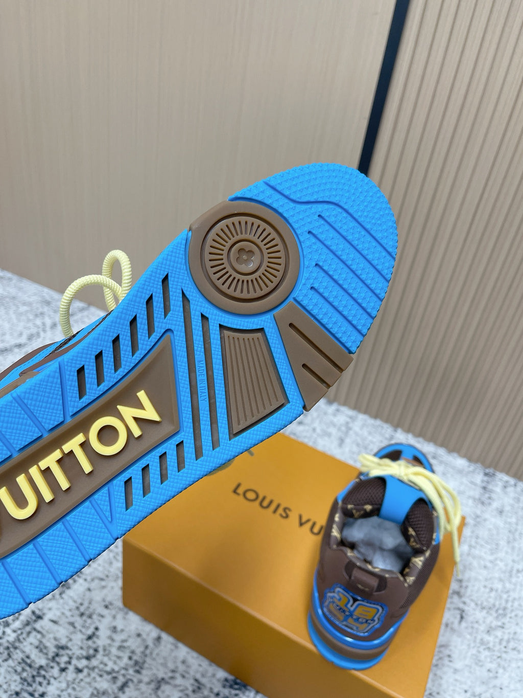 Unisex outsole detail: blue rubber sole with tread and dark brown accents