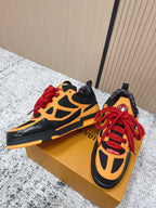 Orange and black high-top sneakers with red laces and patterned heel collar detail.