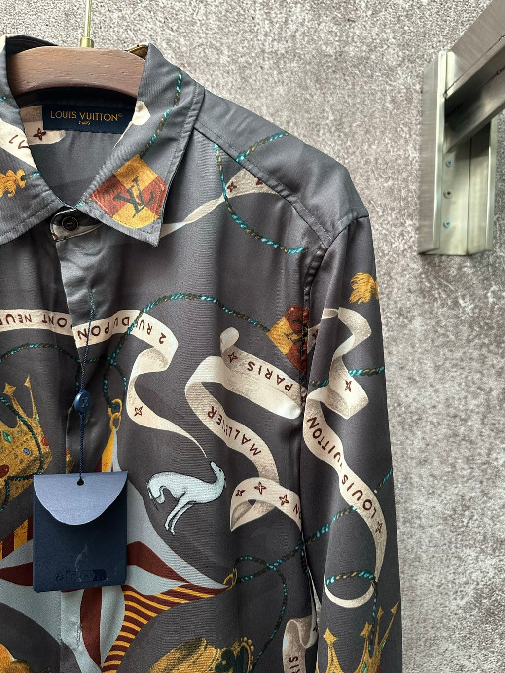 Long-sleeve shirt collar and chest with dark blue and colorful graphic print detail.