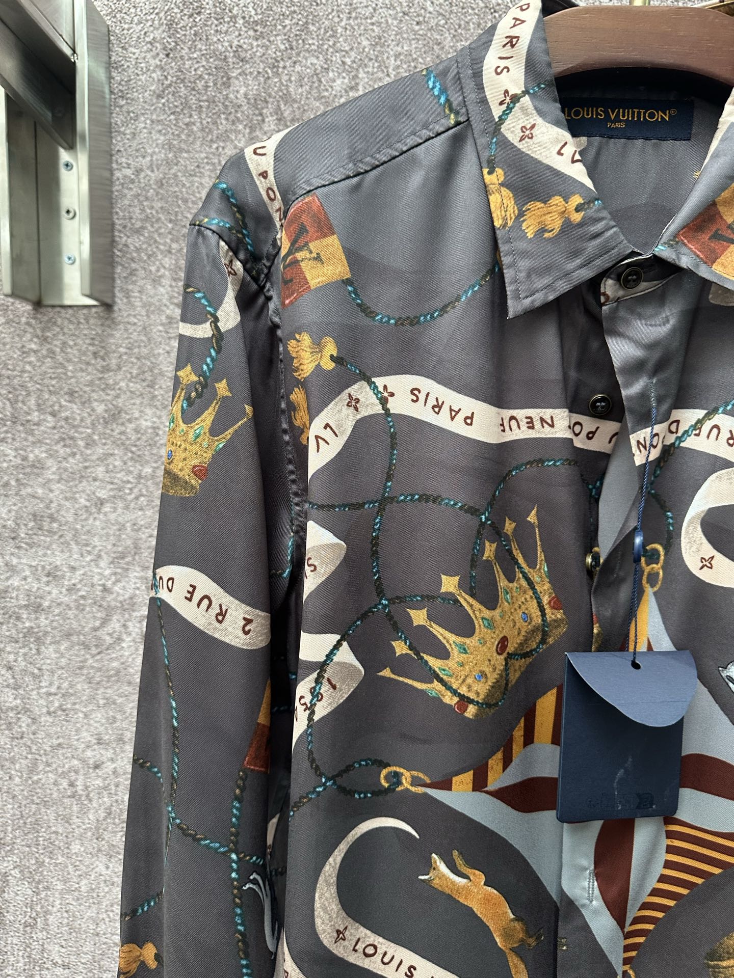 Long-sleeve button-up shirt with dark blue ground and colorful animal and chain motifs.