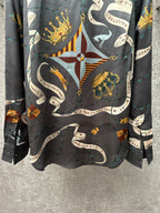 Long-sleeve button-up shirt front view with dark blue central crest and chain design.