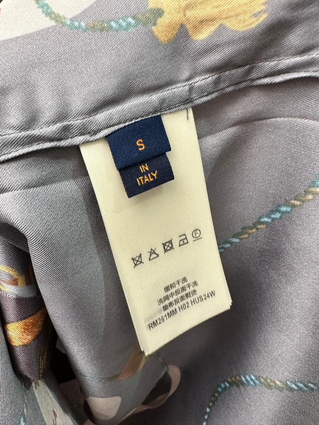 Louis Vuitton pants inner label on gray fabric with care symbols and multicolor print