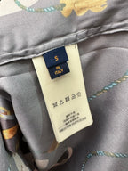 Louis Vuitton pants inner label on gray fabric with care symbols and multicolor print