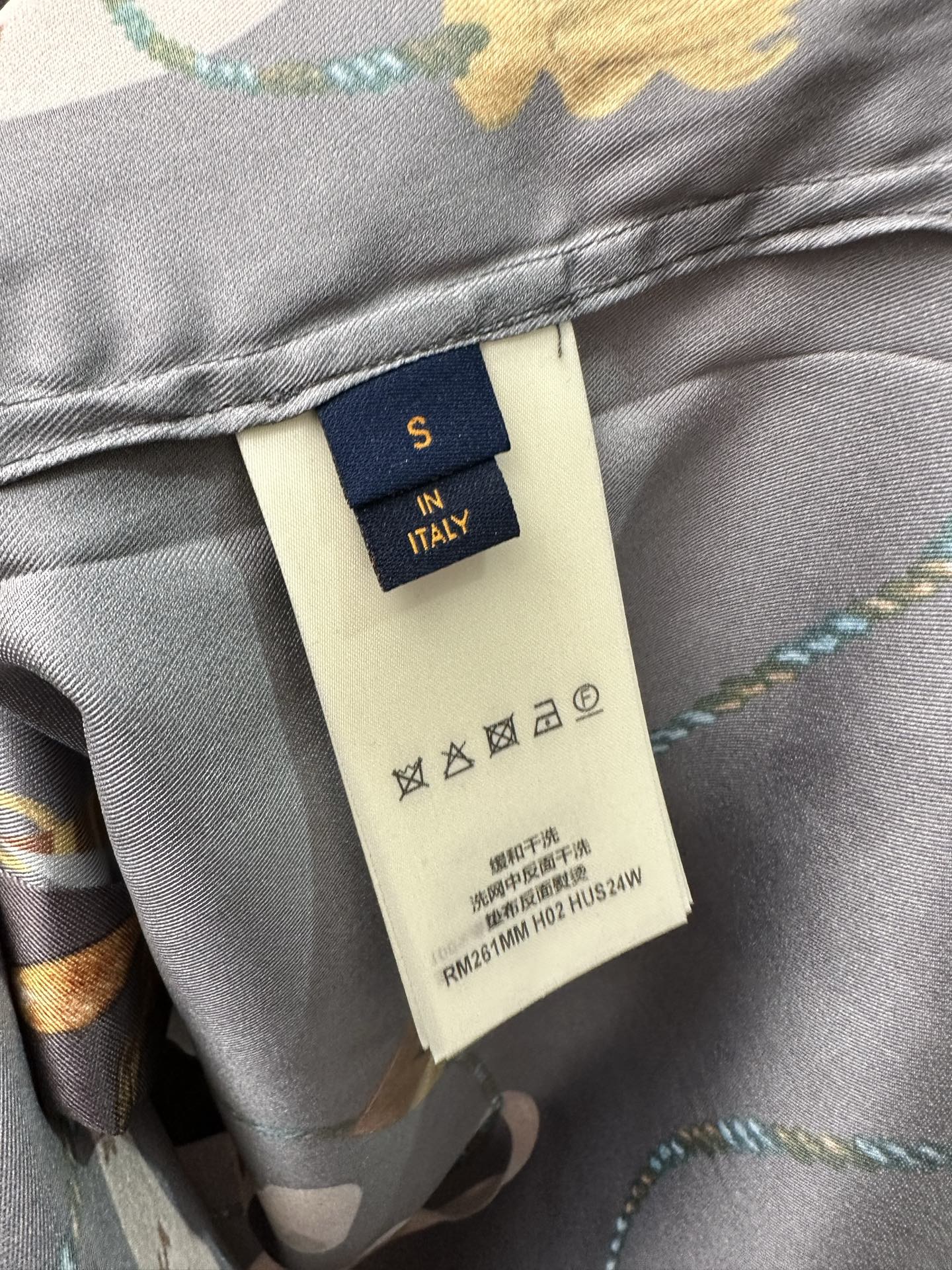 Louis Vuitton pants inner label on gray fabric with care symbols and multicolor print