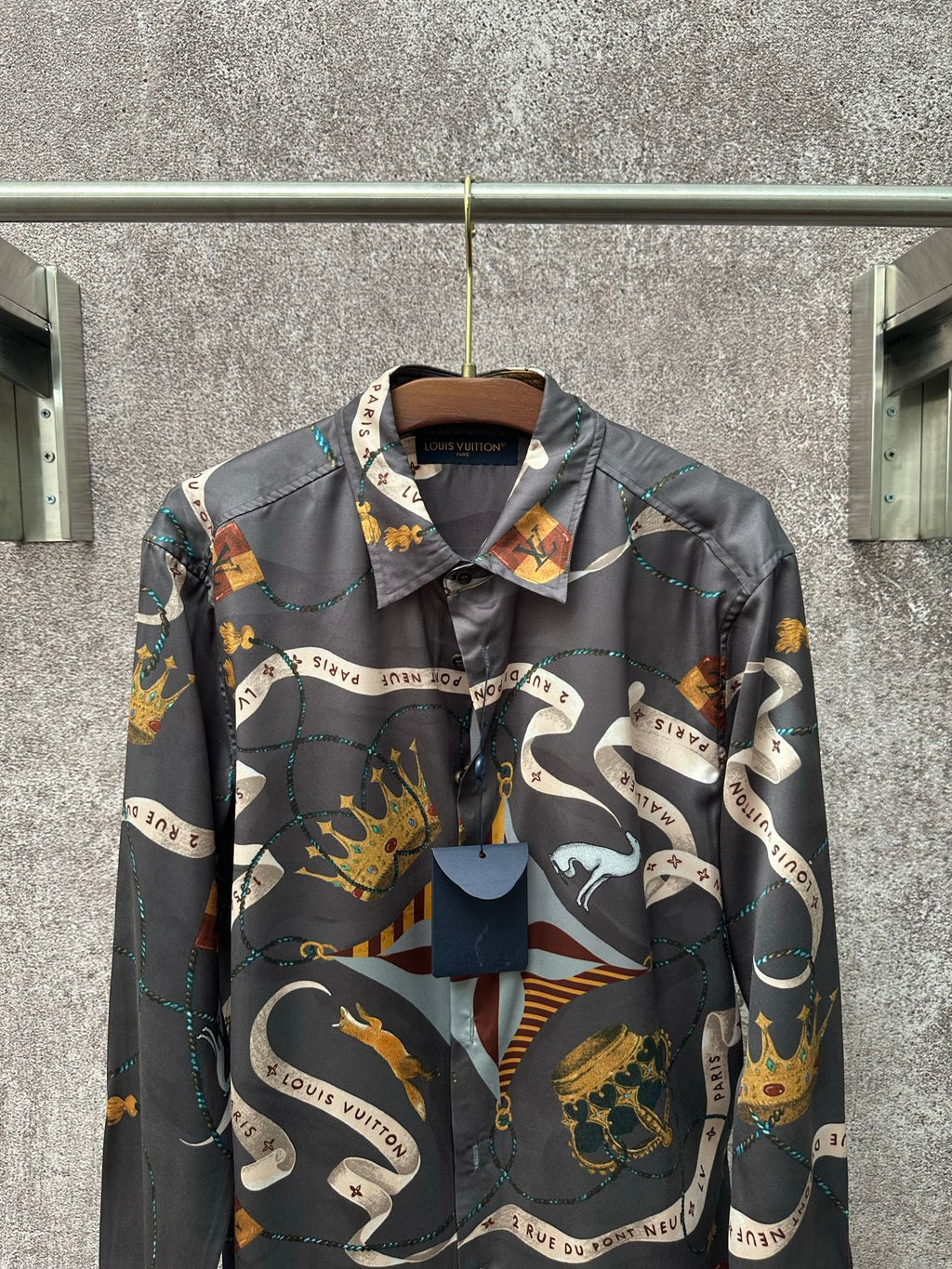 Long-sleeve button-up shirt in dark blue with colorful graphic scarf-style print.